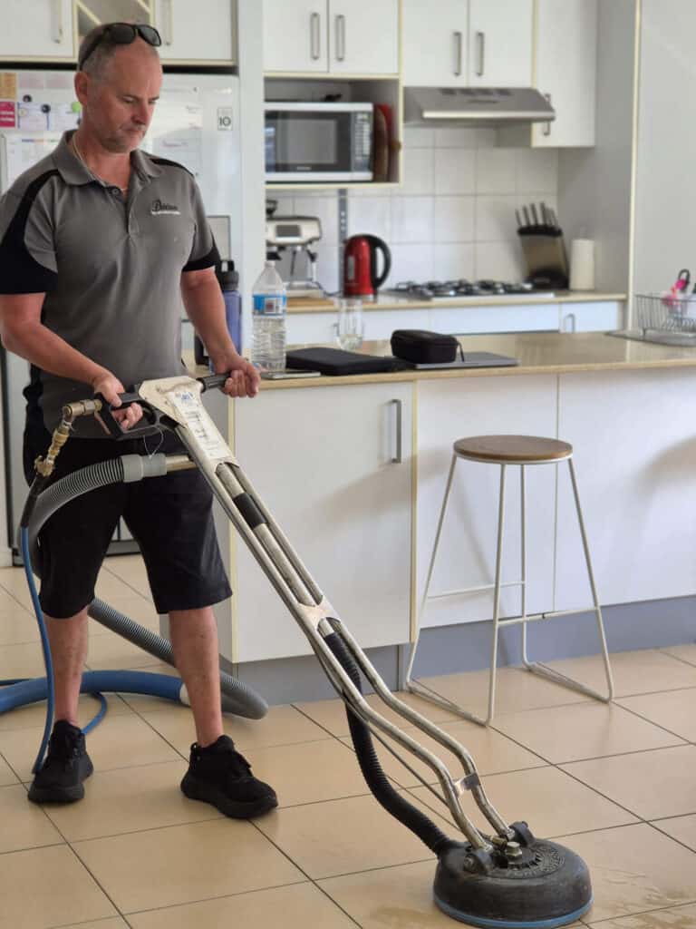 Gold Coast Tile Cleaning's Tim cleaning tiles in dining room